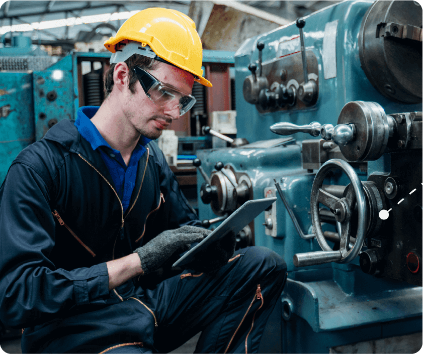 Maintenance worker in a hard hat holding a tablet
